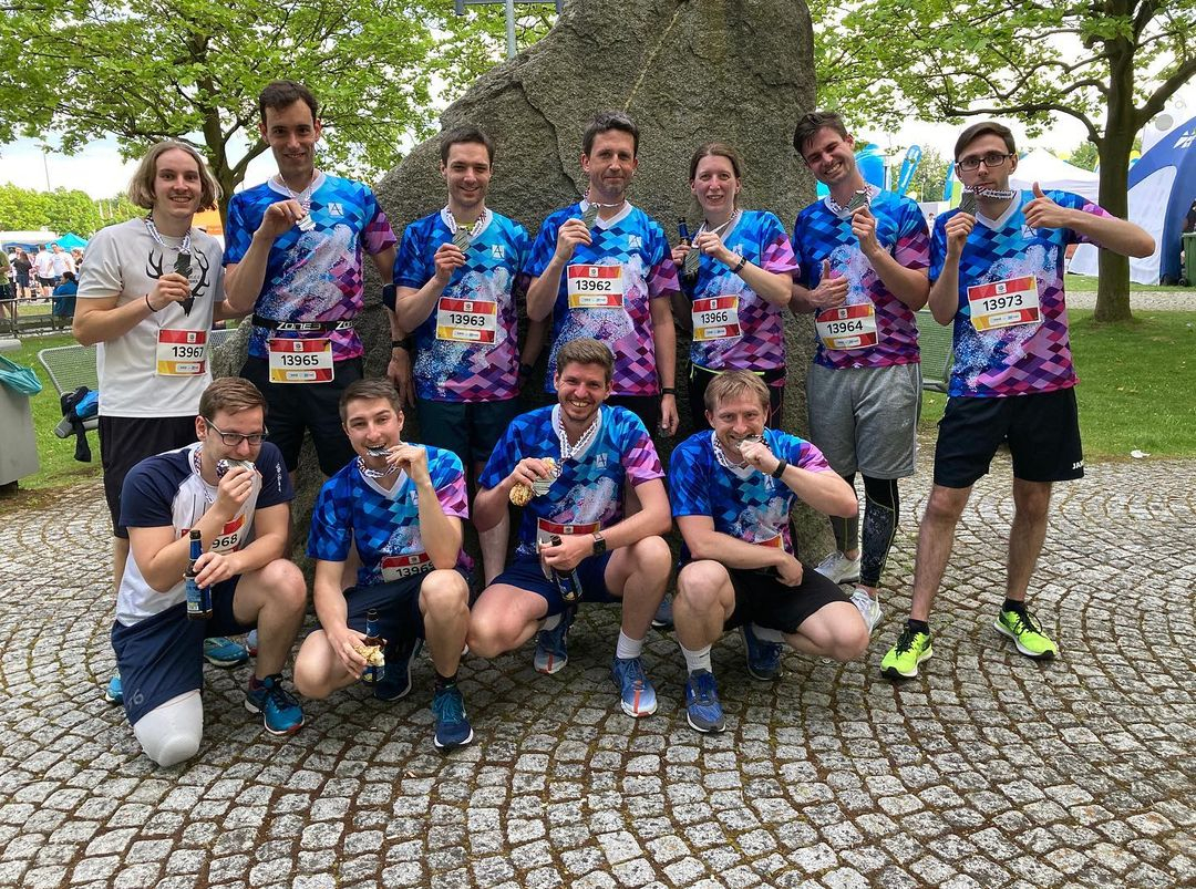 Group photo of the 11 employees who participated in the company run in Augsburg.